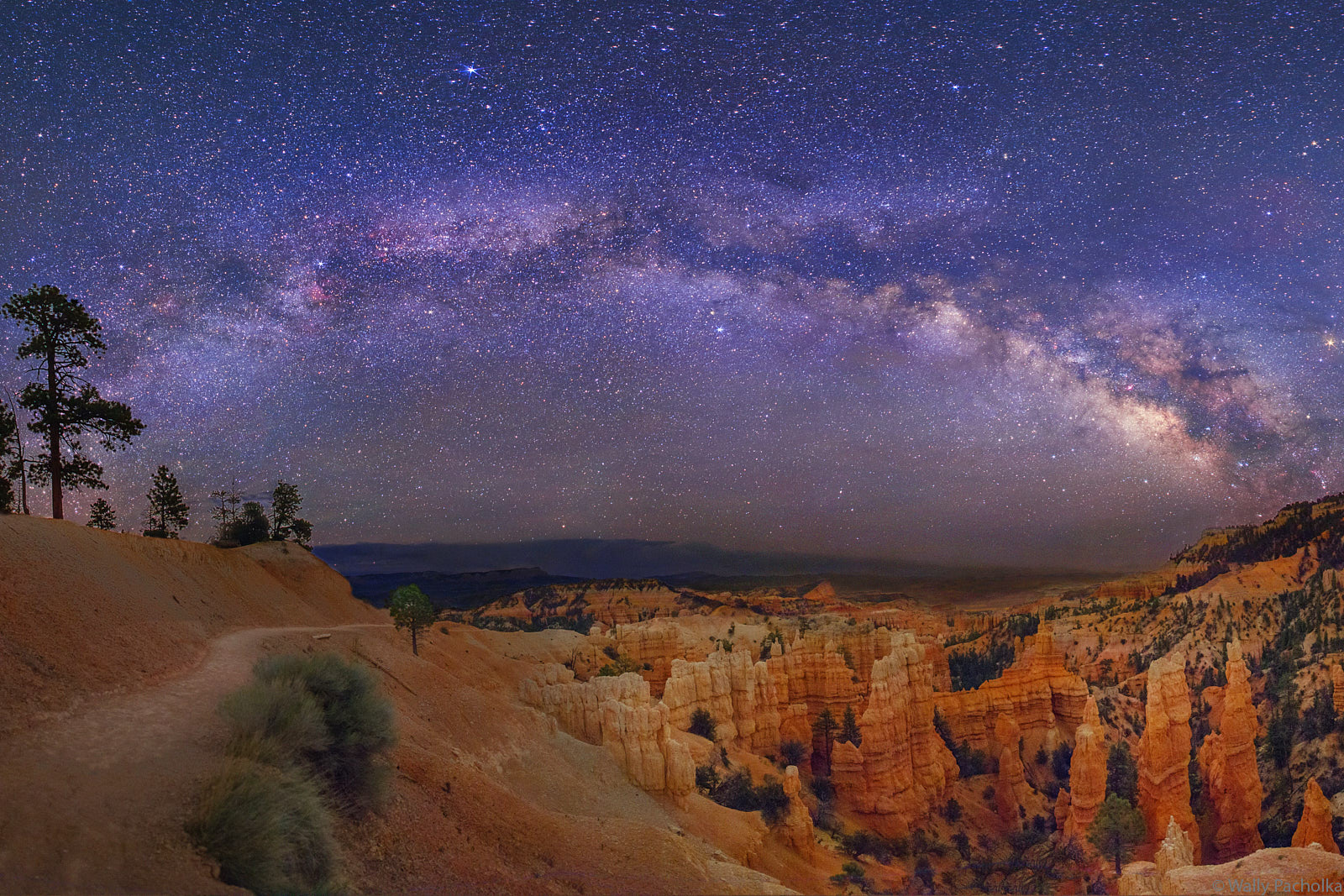 Hiking the Fairyland Trail under the Milky Way The Milky Way spiral arm reaches over the Fairyland Trail in Bryce Canyon.