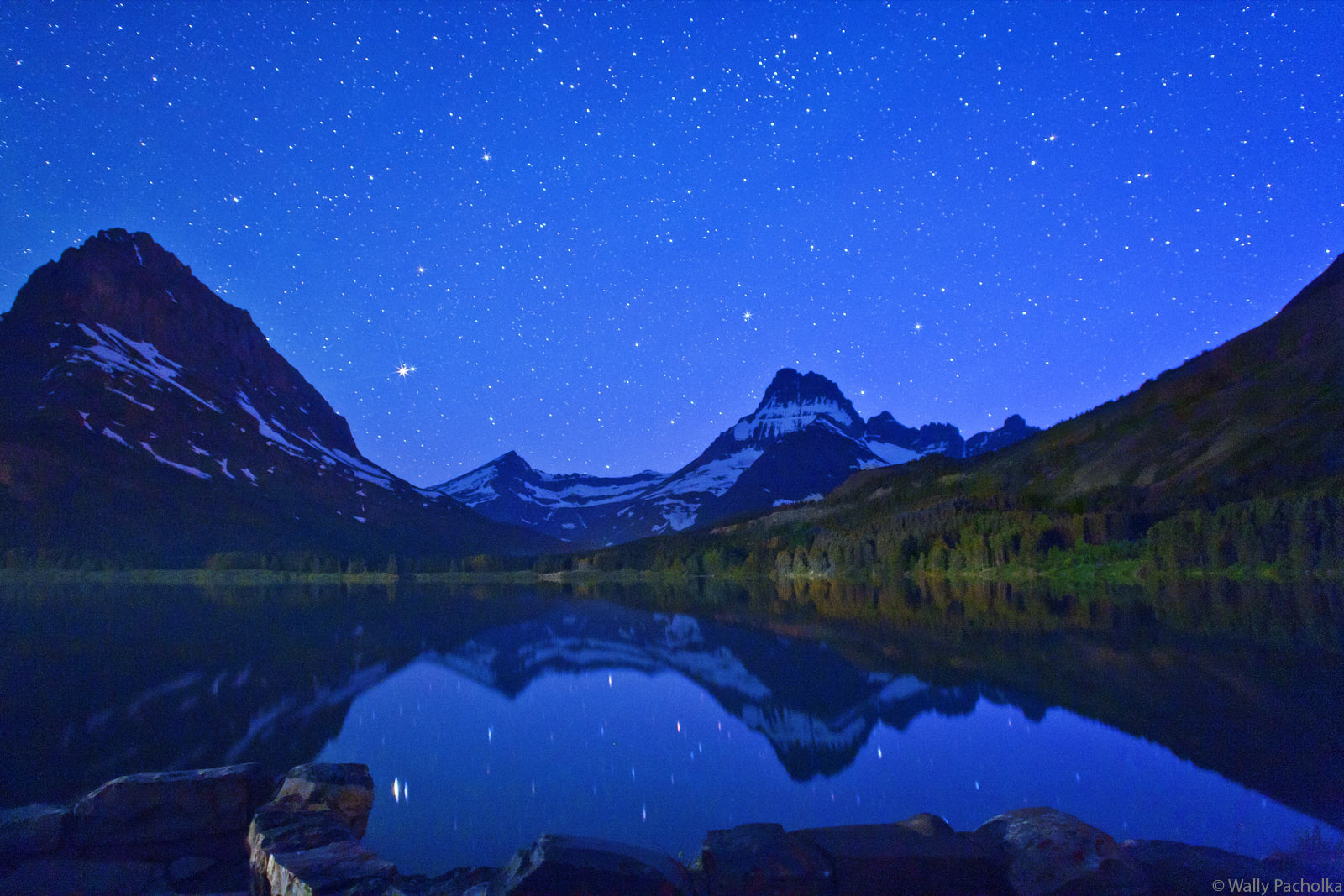 Many Glacier Swift Current Lake Saturn Reflection Stars and Saturn reflect in the Swift Current Lake in Glacier National Park.