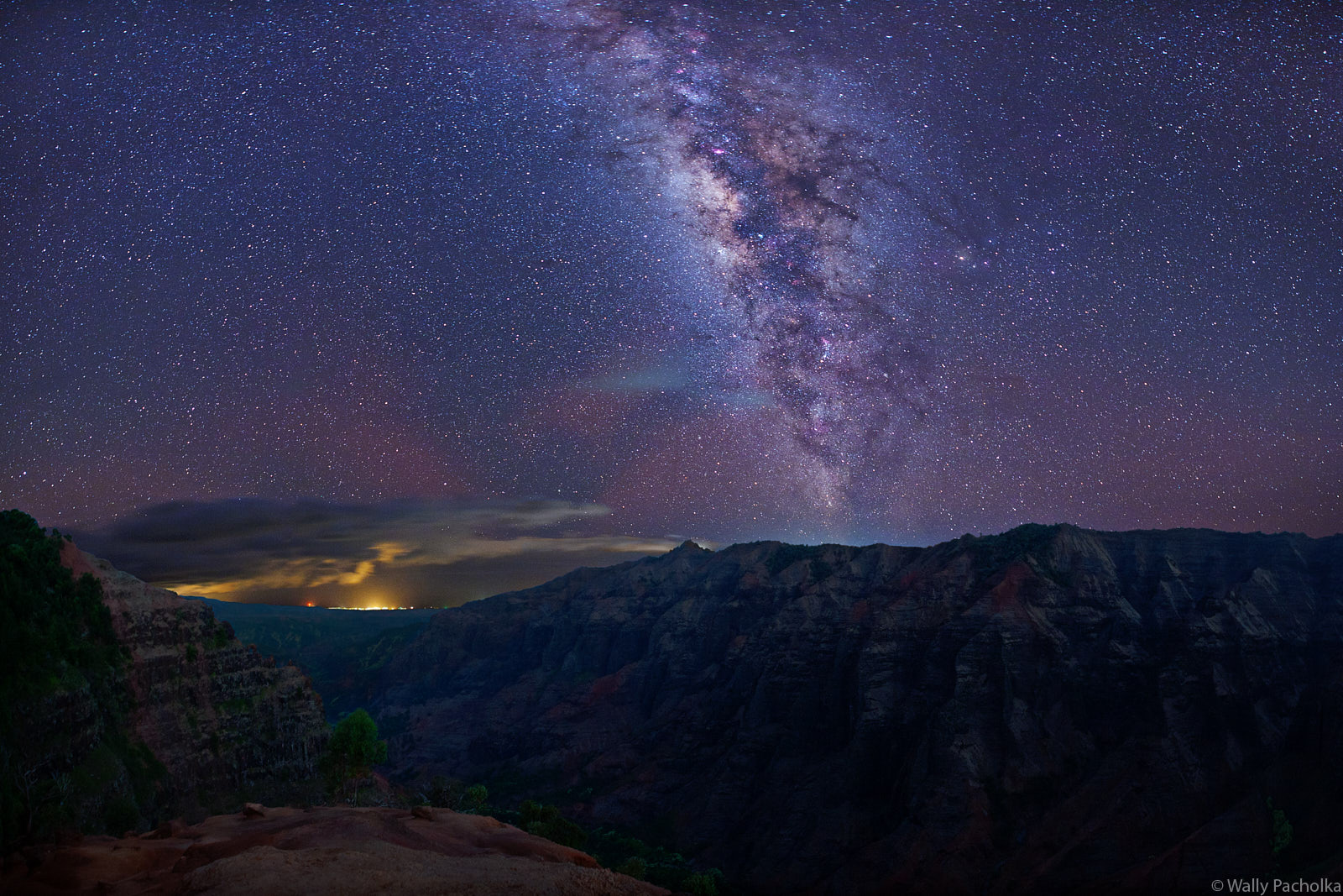The Milky Way rises up from Waimea Canyon and Port Allen on the island of Kauai in Hawaii,
