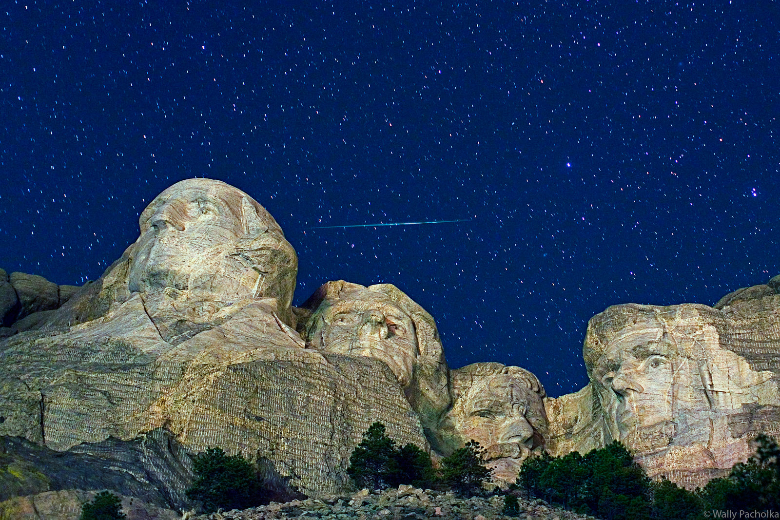 A meteor streaks over Mount Rushmore.